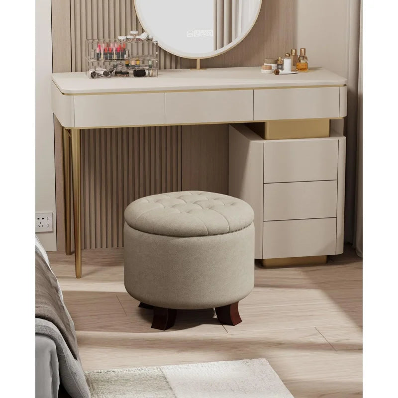 Round footstool, upholstered with storage, taupe and black.