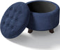 Round footstool, upholstered with storage, taupe and black.